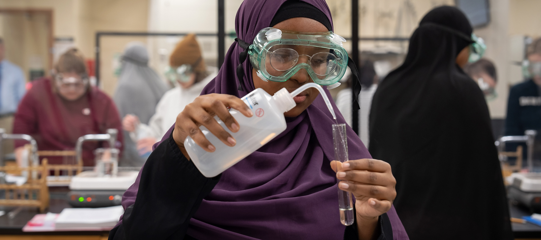 Students using lab equipment while taking chemistry classes  and pursuing their Associate Degree in Chemistry from Normandale Community College.