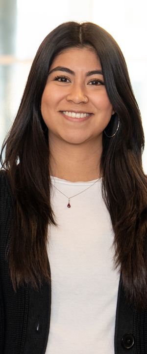 A Normandale student in red sweatshirt smiles.