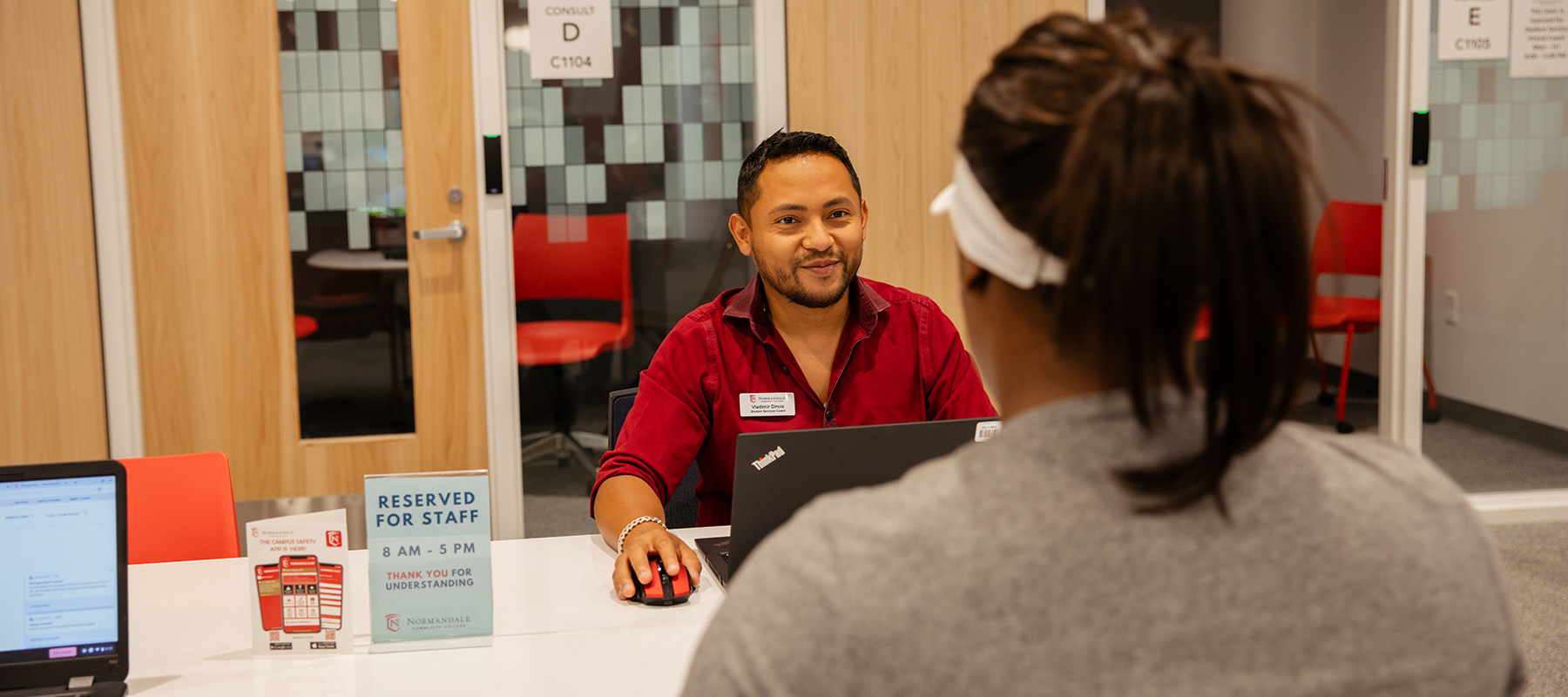 A Normandale Student Services Coach consults with a student.